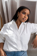 Relaxed white button-down shirt styled with light blue blue denim