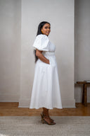 Full-body shot of model in white midi dress