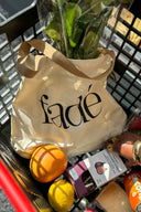Lifestyle shot of tote bag and groceries in shopping cart