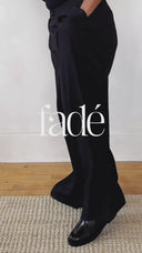 Folded pants and shirt showcasing stitching quality